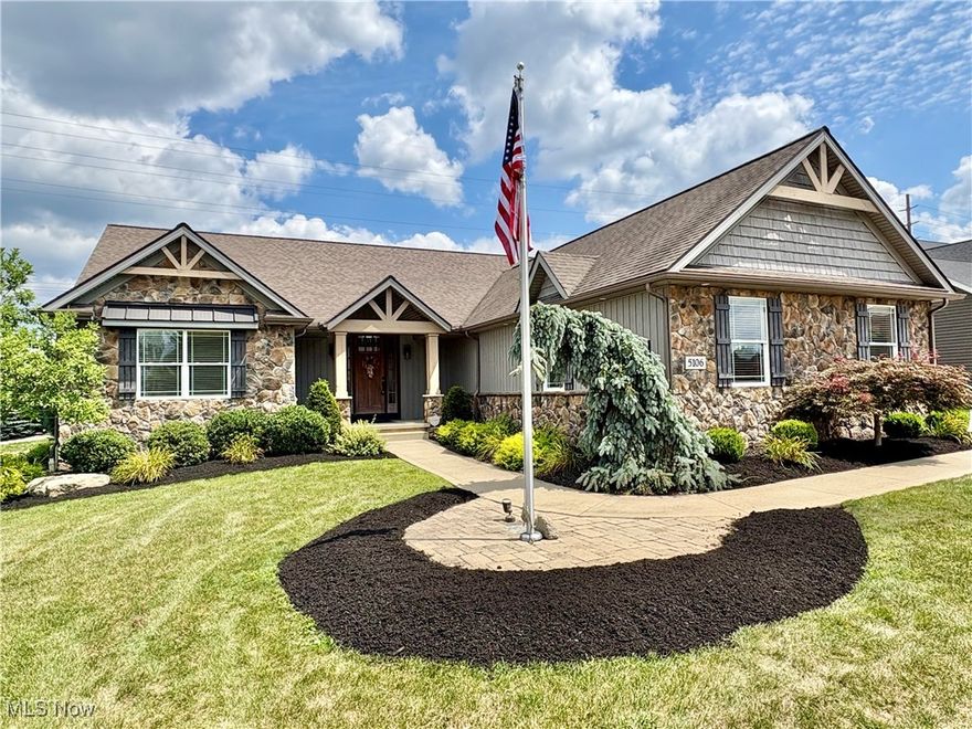 Welcome to this exquisite custom-built Kauth Parade of Homes ranch, perfectly situated in desirable Jackson Township, Scotsbury Glen. Enjoy unparalleled convenience with grocery stores and restaurants just moments away. This stunning residence offers an attached three-car garage, including one heated bay, a true luxury for any season. Step inside to discover reclaimed barn hardwood floors that flow through the expansive, open-concept living area. Here, a captivating stone gas fireplace creates a warm and inviting ambiance. The gourmet kitchen is a chef's dream, boasting a wall oven, range, refrigerator, and a generous pantry. Entertain with ease at the dedicated wine bar, all complemented by sleek granite countertops.The dreamy primary suite is a private sanctuary featuring vaulted ceilings and a spa-like en-suite bath. Indulge in the luxurious tile floors, his and hers vanities, a spacious walk-in tile shower, and a separate soaking tub. A massive walk in closet caps off the primary suite! Thoughtfully designed, the guest bedrooms are generously sized and privately located on the opposite side of the home, offering comfort and privacy for visitors. The shared guest bath also features elegant granite counters and tile floors. Extend your living outdoors onto the charming screened-in porch, perfect for enjoying the fresh air. The basement offers incredible potential with a partially finished section and a full bathroom, providing ample space for storage, a workshop, or even a dedicated home office. Outside, the property is an entertainer's paradise. A beautiful stamped concrete patio with stone walls sets the stage for gatherings, complete with a cozy fire pit. The fully fenced-in backyard features pet-safe artificial turf, offering a low-maintenance and pristine outdoor space. This home truly combines luxury, comfort, and prime location!