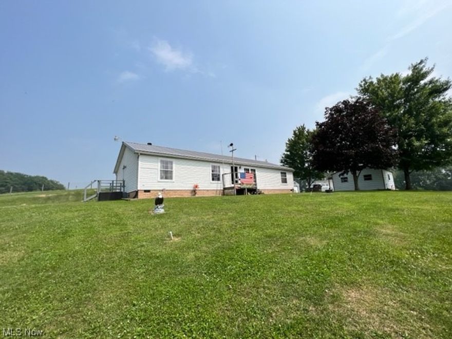 Own your own private retreat! This beautifully remodeled 1 story home is situated on 4.8 acres with gorgeous views of the valley. There are 3 bedrooms, 2 full baths, a first-floor laundry room, and a screened in back porch. There are several outbuildings that include a 14x28 garage, a 20x18 garage, a 10x16 storage shed, and a heated workshop with an attached storage area that has 200 amp electric, and a 50 amp plug for a RV hookup. The home is in move in condition with a great open concept floor plan. The kitchen has new cabinets, a center island, and includes the appliances. There is a nice formal dining area that leads into the family room that has a wood fireplace. The master suite has a walk-in closet, a double vanity, and a large walk-in tile shower. The entire home has all new flooring. The screened in back porch perfect to enjoy a quiet evening and enjoy the beautiful landscaping. The home comes equipped with a generator. There are 2 water wells, one is used for outside use only. The metal roof was installed in 2021. This stunning tree lined property offers so much peace and tranquility that you will never want to leave.