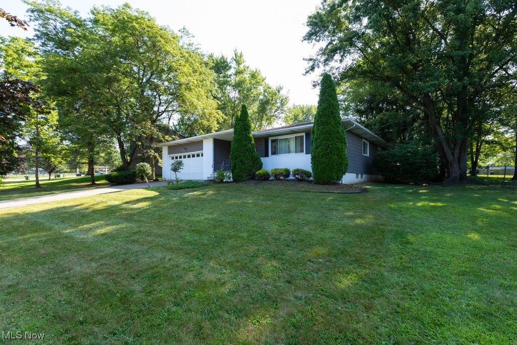 Spacious ranch home is in the Indian Creek Estates community of Macedonia, conveniently located near Rt 82, I271 and I480, and just minutes from the Macedonia fitness center, shopping, and dining. This 3 bedroom home has 2 full baths on the main floor, and a 3rd full bath in the finished basement. Room sizes are spacious, and the family room with fireplace is a favorite gathering place. The living room and dining room are adjoining with wood-look laminate flooring. This floor plan allows for larger gatherings in one area. The kitchen has an island that is movable. All appliances, including the washer and dryer, stay with the home. The roof was replaced about 4 years ago. The finished basement includes the laundry area, utility room with additional gas range, large recreation room, and three more rooms with closets (potential guest rooms/offices). There is also a full bath in the basement. When the above ground pool frame broke, some of the large amount of water released seeped into the basement and damaged the carpet and the bottom of the drywall. This was professionally dried and cleaned up by ServePro, and is scheduled for complete restoration. The pool will need to be removed or replaced. Once the restoration is completed, the finished basement will again offer a generous amount of additional living space. This home offers one floor living in a popular Macedonia community. With your finishing touches, you can make this your own fabulous home! Being sold As-Is.