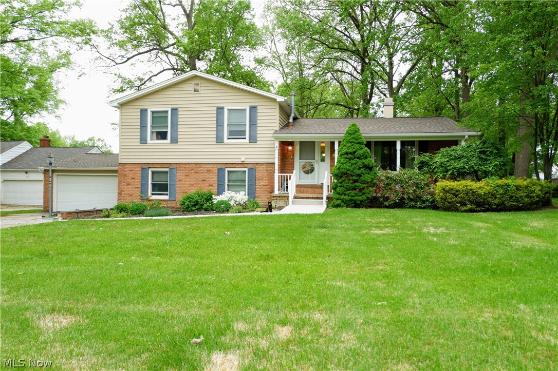 This quad level 4 BR split has been well maintained and nicely updated. The welcoming front porch opens to a light- filled interior with a spacious and open floor plan. Low maintenance ceramic and wood flooring flows through the main floor. The large foyer leads to the living room with hardwood floors and a cozy wood- burning fireplace. Continue through to the big dining room that's perfect for entertaining. The adjacent updated kitchen features lots of cabinets and counter space, a pantry, and a spacious dinette area. You'll find three big bedrooms and two full baths upstairs, including a generously sized master suite that easily accommodates king sized furniture. The spacious lower level offers a huge family room with built in cabinetry and lots of storage; a 4th bedroom (currently used as a craft room), and full bath/ laundry room located off the family room. Sliding doors lead to a covered patio overlooking a beautifully landscaped backyard! The partial basement has been fully wat