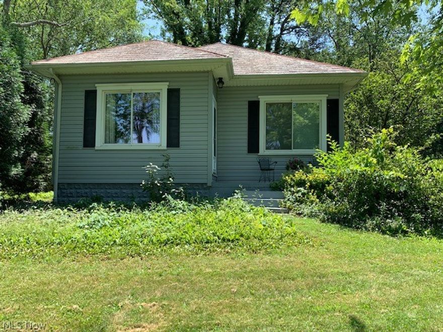 Cute bungalow situated on 3.99 acres m/l offering updated eat-in kitchen with stove, refrigerator, and dishwasher, updated bath with garden tub, separate shower, nice size living room with doors to side deck, two bedrooms.  Basement offers laundry hookups, storage, you decide!  Two car detached garage with one door opener.  Shed and above ground pool.