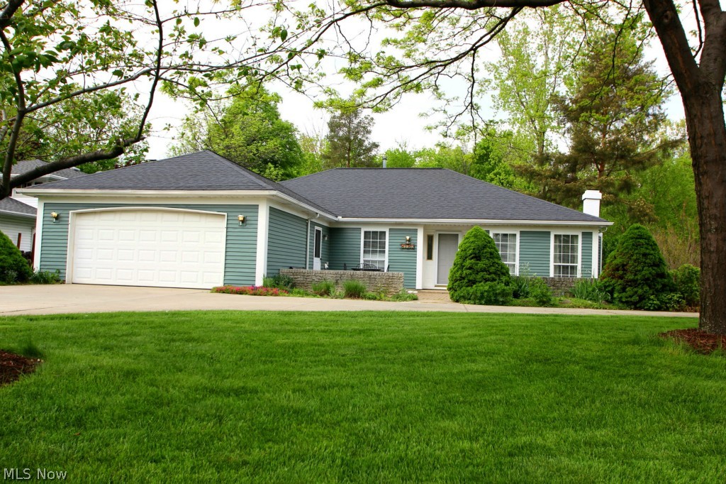 Former Parkview model home. Amazing curb appeal! Front offers professional landscaping, paver patio & circular driveway. Spacious living rm accented with brick WB frplc & large windows. Eat in kitchen features high ceiling, ample counter & cabinet space, pantry, ceiling fan, track lighting and internal glass blind sliders leading to deck. Cook on your electric flat top range & newer double oven! Formal dining rm & additional office/den or family rm. Large master bdrm w/ walk in closet, private bath & sliders leading to back deck. 2 additional beds and full bath. Laundry rm has entrance to oversized 2-car garage w/ shelving & plenty of storage. The home's been converted to gas heat & has newer windows throughout. Sit on your back deck and enjoy nature in this private park-like setting complete with storage shed, greenhouse to grow your own fruits, vegetables & a yard which backs to a peaceful spring fed creek. Truly a special property, come see it today!!