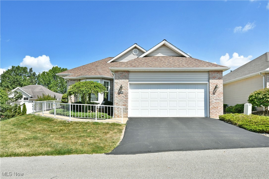 Casual comfort in a quiet, high demand development is what you’ll find as you explore the gorgeous views of this move-in-ready Austintown home! This stunning condo has it all, beginning with a prominent corner lot, just moments away from the clubhouse. Lush landscaping hides a privacy fence lined corner patio as picket lined sidewalk makes its way past the two car attached garage and the handsome brick work that accompanies it. Inside, a brightly lit and tiled foyer gives way to the third guest bedroom, providing colorful surroundings and a wrapping, bay styled window. Meanwhile, the central great room wows with its tall ceilings and windows, offering up fantastic, bonus bar top dining that overlooks the kitchen. Here the large serving window peers in towards an array of stained wood cabinets and bright white appliances. Across the hall, a substantial full bath provides a floor entry shower and its elegant vanity. First floor laundry service awaits garage access. Further down the hall, a second guest room highlights is shimmering hardwood flooring and large closets. The master suite delights with its own walk-in closet and full private bath with a large vanity, additional floor entry shower and private commode. The full basement allots for easy storage and utility access to include a home generator.