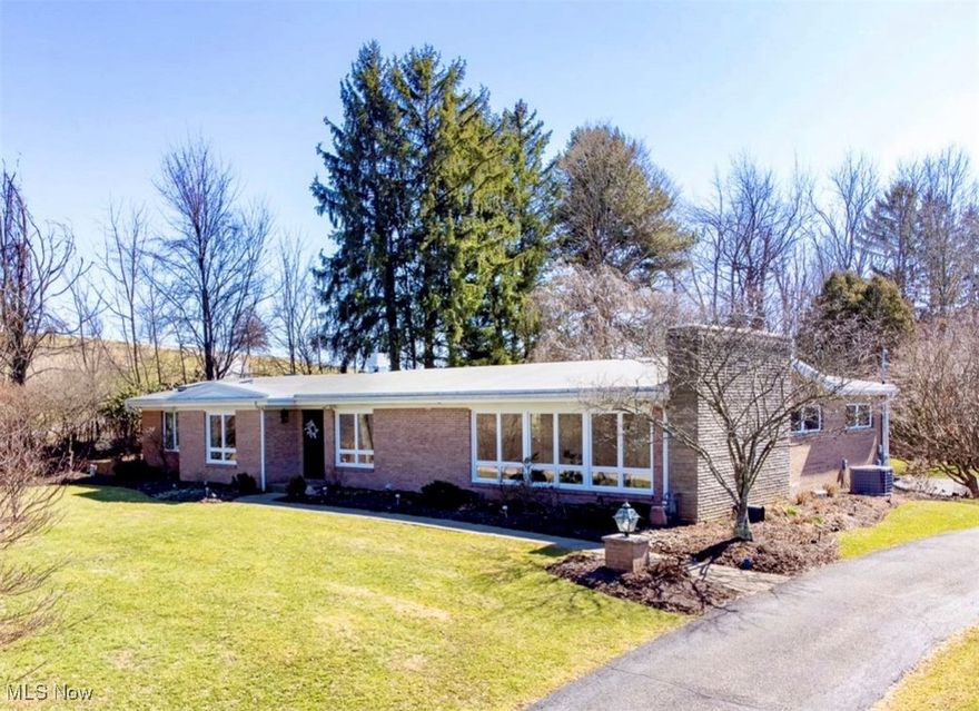 Welcome to this exceptional ranch-style home where modern comforts meet serene living! This 3-bedroom haven, 2 full bath brick home is in one of St. Clairsville's most desirable locations.  Skylights and tall windows flood the home with natural light, creating a bright, airy atmosphere. Two distinct sunrooms open up to a private outdoor patio oasis. Meticulously designed professionally landscape frames the property with a variety of flowering plants, shrubs and a gorgeous weeping cherry tree. The master suite is a true retreat, featuring a newly updated spa-envy wetroom with heated floors and waterproof porcelain tile designed for ultimate relaxation. Step into the heart of the home: a centralized kitchen featuring clever pass-throughs that connect to a cozy den, a formal dining room and sunroom, ensuring that preparing meals is always a shared, delightful experience with family and friends. Enhancing the ambiance further are two inviting gas fireplaces that add character and comfort to the living spaces. With a park just a short stroll away, outdoor activities and leisurely picnics are always within reach, making this property ideal for nature lovers and families alike. This home has undergone many updates including new windows, skylights, furnace, air conditioning, storm doors, garage doors and many more. Don't miss this chance to experience the perfect blend of indoor comfort and outdoor tranquility! Call your favorite realtor today!