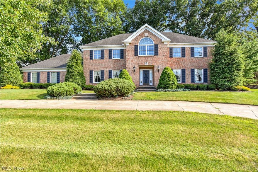 Stately brick Colonial, original owner/custom built by Marchetta, in desirable Arbour Green in Bath.  Nestled on 1.5 nicely landscaped acres with a level back yard, mature trees and a pond (shared/no cost).  Drive up the circular drive and step into the impressive grand foyer with a curved staircase and Italian marble floors. Formal living and dining rooms and a office/study with crown moldings and built-ins.  Schrock Gourmet eat-in kitchen with center island, double ovens, planning desk and French doors to deck. The engaging family room features a fireplace, custom built-ins and a wet bar. First floor laundry and 2 half baths.  Spacious second floor master suite with walk-in closet and spa style bath.  Three additional large bedrooms, two full bathrooms and loft area complete the upstairs. Three-car garage with two doors, hot and cold water, drain, second driveway.  Newer roof, newer furnace, 2 hot water tanks, security system, whole house vac, basement plumbed for additional bath. Ho