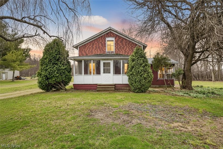 This cozy small farmhouse on partially wooded three acres, with a vernal pond, offers a unique opportunity for homesteading on a well-loved piece of land. Owned by the family for decades and thoughtfully updated over the years, it has surprising modern amenities for an older home including central air, first floor laundry, first floor full bath and the most amazing west and south-facing sunroom with vaulted ceiling added by the family for summer gatherings and exterior access for a home based business. The efficient first floor layout features a generous and welcoming front porch, a large living room with a built-in home office, a dining room equipped with a wood-burning stove, and a fully equipped eat-in kitchen. Also on the first floor is a bonus room with a small closet that could double as a guest bed or a studio/office space. Upstairs are two bedrooms, a walk-in-closet and a half bath. The sunroom has two doors to access the outside patios perfect for summer barbeques or sunbathing. A few other desirable features include replaced windows, interior access to the basement, a new water heater, a turnaround driveway with five parking spaces, a storage shed with electrical service for your tools, a small chicken coop, a trail to the quiet vernal pond amid the woods, and beautiful, established perennials, plants, shrubs and trees surrounding the house. Check out the possibility of what such a lifestyle can be while enjoying the numerous and incredible amenities of Oberlin city minutes away – schedule your virtual or in-person tour today!