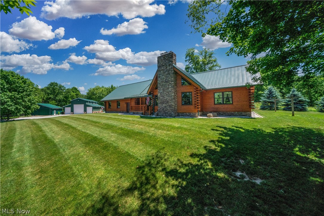 Make an offer! Sellers are elderly and wanting to move into their retirement home. The log cabin was custom built for sellers in 2012. There is no zoning, so you could have animals, more buildings, etc. on the property. This is located on 9.3 acres in a private beautiful setting loaded with wildlife, with a security gate, covered bridge, lighted gazebo. Large 2-3 extra buildings 98x40 and 32x24, 2 pastures & a riding arena. The large building has a fully furnished apartment above it with kitchen and laundry facility, great for a rental or family member. Call for details and a private showing!