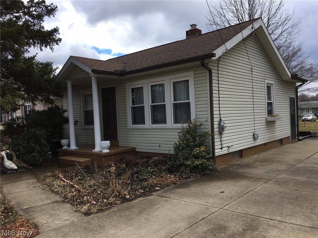 The perfect tiny house! This adorable home offers a living room, dining room kitchen, bathroom, two bedrooms and a full basement. Nice curb appeal, vinyl siding and vinyl replacement windows. All new carpet throughout. The kitchen has laminate counter tops, oak cabinets with gas range and refrigerator included. The large basement provides all the storage space you need. Washer and dryer stay. Updated electrical box. The paved driveway leads back to the cement patio area, covers porch and spacious back yard. The lot behind the house is also for sale. Purchase both for extended space and lots of room to build a garage or out building. Call today for your private showing!