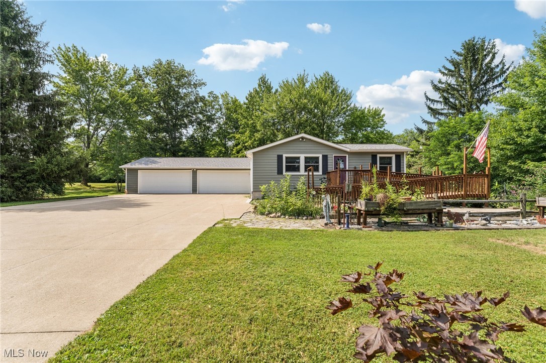 Welcome to this charming 3-bedroom Ranch home in Chardon, OH, nestled on over 2.5 acres of peaceful, scenic land! The long driveway sets the home far back from the road, offering plenty of privacy and tranquility. As you approach the front door, a welcoming ramp invites you to imagine a beautiful garden haven — picture strolling through a lush garden maze right at your entryway. Prefer a more direct entrance? The ramp can easily be removed to suit your needs. Step inside to find a spacious living room with vaulted ceilings that flows seamlessly into the generous dining area — an ideal setup for hosting family gatherings and festive dinner parties. The kitchen sits conveniently at the back of the home, perfectly positioned so you can cook and socialize without missing a moment. To the right of the dining room, a hallway leads to two comfortably sized bedrooms, a full bathroom, and a convenient half bath with a vanity area. Just off the living room, you’ll find the final bedroom — perfect for a home office, guest room, or cozy retreat. Downstairs, the expansive basement offers endless possibilities — from storage and workshops to future finished living space. The attached 4-car garage provides ample room for vehicles, tools, and hobbies, with an additional workroom at the rear for your projects. Outside, unwind on the back deck with your favorite drink and a good book while enjoying the serene surroundings. With the home ideally situated in the center of the lot, you’ll love the generous front and backyard space for gardening, play, or simply soaking in the outdoors. Don’t miss your chance to explore all the potential this beautiful property has to offer — schedule your showing today and envision your future here!