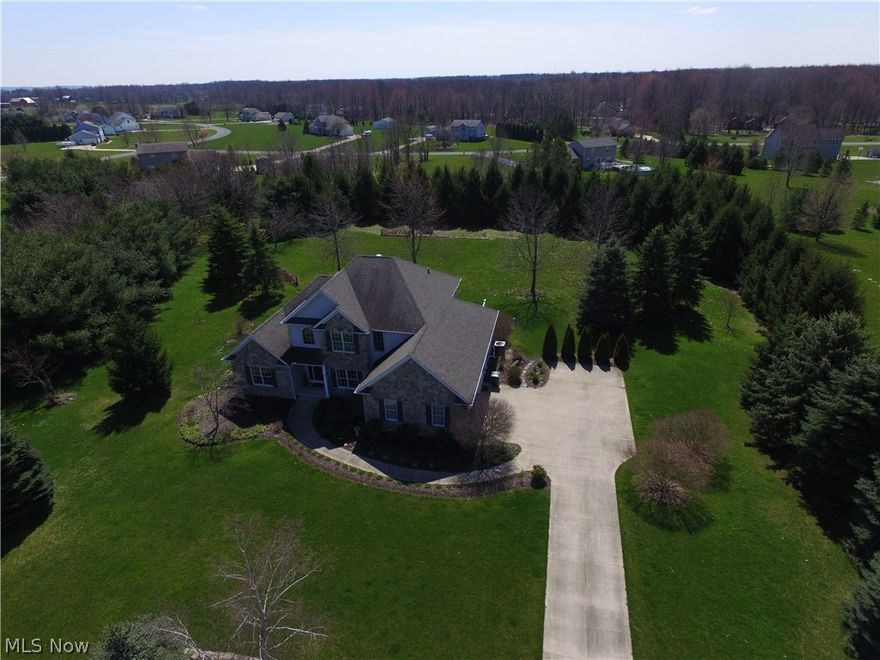 WOW what a gem! Located on the outskirts of Wadsworth, this custom-built Colonial boasts quality & charm throughout!  Immaculate curb appeal with 2+ acres!  A 2-story foyer welcomes guests to this 3 bedroom, 3.5 bathroom colonial. Upstairs loft can easily be converted into 4th bedroom! An office and formal dining room are off the foyer.  1st floor owners suite features open double wall-to-wall closets, sound-proof walls, palm ceiling fan, built-in surround sound (also throughout home plus outside), a gorgeous double vanity private bath with jacuzzi tub and imported Spanish tile throughout.  The owners suite also features its own private deck including a 6 person hot tub that stays!  The large, 2-story Great Room features a beautiful gas fireplace and a wall of windows overlooking the private rear yard.  Updated granite island kitchen features plenty of cabinet space and walk-in pantry!  Deck #2 is just off the kitchen and has plenty of room to entertain your favorite guests!  Partially