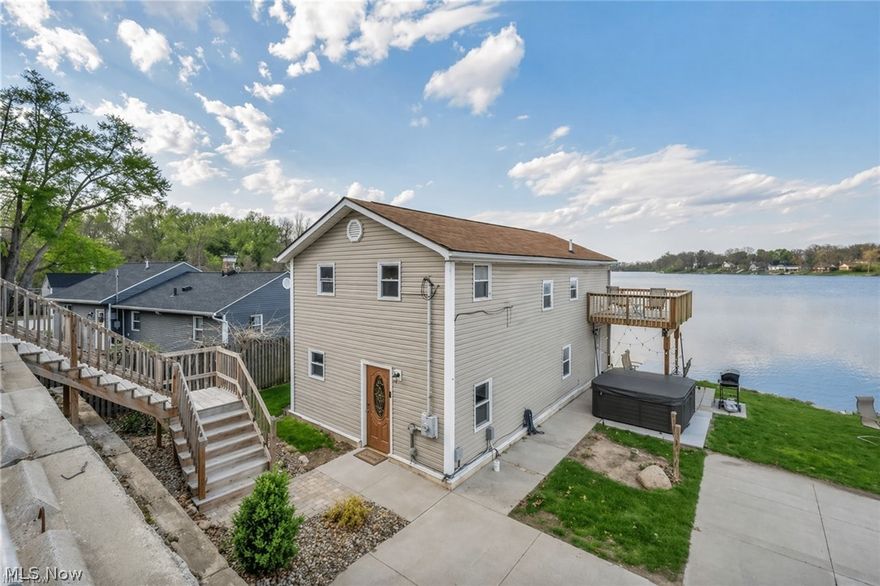 Wake up to shimmering water views in this beautifully renovated 3-bedroom lakefront home on Long Lake. Whether you're looking for a personal retreat, a full-time residence, or a cash-flowing investment, this property checks every box. The current owners have already invested in the major infrastructure items that typically concern buyers. The septic system, retaining wall, and driveway leading down to the house were all replaced in 2021. The sea wall, built approximately two years ago, protects the shoreline for decades to come, and brand-new steps down to the house were installed in 2025.  Inside, the main living areas capture sweeping water views, and the primary suite features a private balcony perfect for morning coffee or sunset wind-downs. 

The outdoor space truly shines. With private shoreline and direct water access, you can fish from your yard, launch a kayak anytime, or simply relax and take in the scenery. A hot tub sits steps from the water, a firepit invites evening gatherings, and a lakeside grill area makes entertaining effortless.

All furniture, decor, and contents are negotiable. A member of the selling entity is a licensed real estate agent in Ohio.
