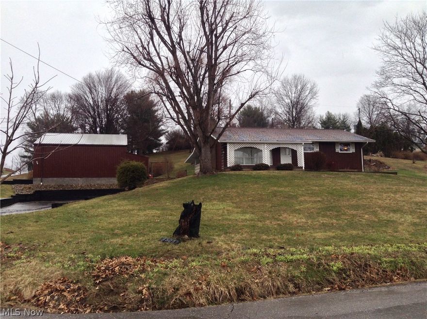 Great Home on corner lot featuring an  1,792 sq foot detached garage that  is ideal for car enthusiast or workshop.   Home has an attached 1 car garage in addition.    18' x 22' Covered patio is perfect for enjoying the outdoors.    Third bedroom setup as a hobby/sewing room.