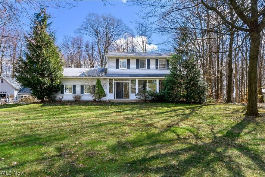 This one is just waiting for you! 4 bedroom 2 1/2  bath Colonial on 5 acre lot -with a quiet country feel, privacy, wildlife especially birds-family of barred owls.  The flowers around the house are mostly perennials give a good display – Japanese peonies in front of the house-Spectacular. Kitchen garden can provide summer vegetables, and the berries!  3-season enclosed porch is favorite place to read, play board games, the back deck (and what a deck it is-perfect for summer BBQ/ dinner in general. The back garden, lawn and swimming pool are perfect for parties. Kitchen is updated-dream baker’s kitchen. The  wood behind the house is wonderful to explore when and provides for the stove in the family room.  
Enjoy playing outside, or at the pool. This house’s location on the north side of Wooster and close to shopping and freeway and is convenient to downtown as well as Akron and Cleveland.  award winning, Amish-built-Hobby Barn – one side a workshop, the other a garden shed and upstairs a huge amount of storage-with water and heat. 
Upgrades:
Appliances both stoves
New roof on two-story hobby barn (2022)
New chimney (2022)
New enclosed porch (2022)
New floor in workshop of hobby barn (2024)
New kitchen counters and built ins (2023)
New gas double oven in kitchen (2023) (a second gas oven is in the basement utility room)
New flood protection drain system in basement (2024)
New carpets in front room, family room and third upstairs bedroom – will be installed after furniture move.
Garage is freshly painted (2023).  House interior paint will be refreshed after furniture move.
Both septic tanks are newly drained (2024) 
New house water filtration system (2023)
Front garden patio (2011)
Heated 24 foot swimming pool with a deep end (2011), the heater was replaced in 2020  (Family Pools, Wooster).
Hot tub
Fruit trees and berry bushes (yasu, grape, red current, blackberry, gooseberry).
Kitchen garden
Flower beds
Massive back deck with railing