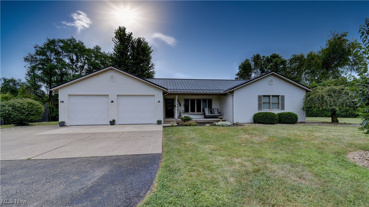 Auction Day is Thursday, September 25, at 6:00 PM. Located just outside of Benton in the East Holmes School District, this ranch home sits on 1.97 acres and offers both comfort and convenience. Built in 1998, the home features a low-maintenance exterior with vinyl siding, a metal roof, Trex decking, and a concrete apron leading to the attached two-car garage. Inside, you’ll find a functional layout that includes a kitchen with eat-in bar, dining area, living room, first-floor laundry, and a primary suite with bath and walk-in closet, along with two additional bedrooms and a full bath. At the rear of the home is a bright 12’x16’ bonus room that opens to the back deck. The full basement provides a large open space with a drop ceiling, half bath, and utility room, offering endless possibilities for extra living or recreational space. Utilities include water well, septic, natural gas furnace, central air and a generator hook up. The property’s exterior is highlighted by a flat, shaded yard with mature trees, well-maintained landscaping, and a 16’x20’ storage shed currently used as a chicken coop. This move-in ready home is a rare find in a desirable location—mark your calendars, you won’t want to miss it!