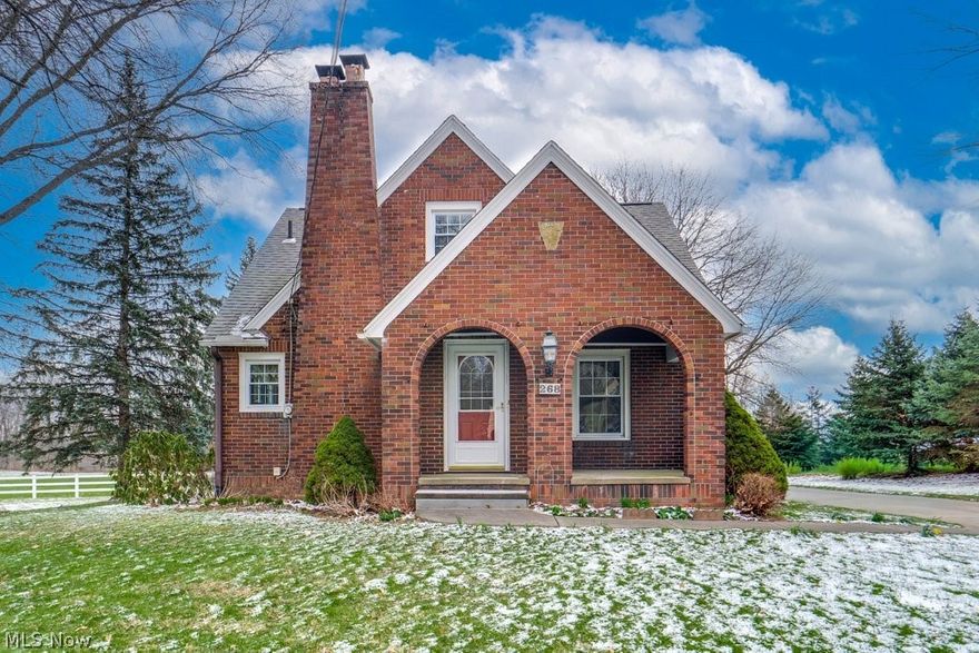 This charming 1930s brick bungalow is rich in character and timeless appeal, featuring beautiful original hardwood floors that extend throughout the living room, dining room, and all bedrooms. Classic built-ins throughout the home enhance both functionality and charm. A stunning fireplace serves as the focal point of the cozy living room, which opens seamlessly to the dining area—perfect for everyday living and entertaining.  Situated on a spacious 1-acre lot in a convenient location near Dalton Schools, the property also includes a 3-car garage and an outbuilding with electric, water and a new metal roof—ideal for a workshop, studio, or "she-shed". A generator is included and wired to support most of the home, providing added peace of mind. Enjoy quiet evenings on the beautiful rear deck overlooking the expansive, private lawn.  This home has been lovingly maintained by the same owner for more than 50 years.  You don't want to miss it.