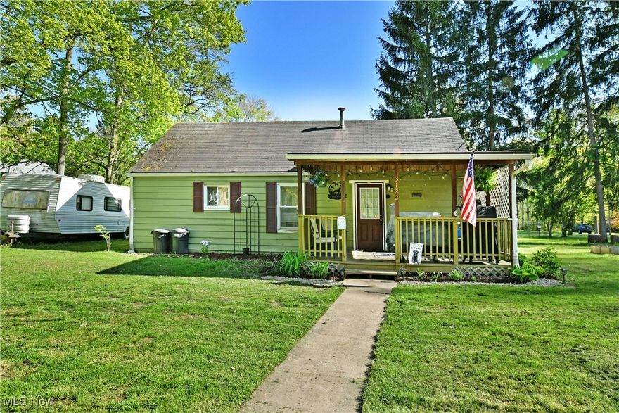 Cozy and charismatic, this darling Bazetta Township ranch has all the right touches to make your daily getaway dreams come true.
Tucked beneath the trees, this inviting home offers a unique, private setting you truly have to see to appreciate. The two-bedroom residence is framed by manicured landscaping, while a substantial covered front porch sets the tone for curb appeal. It's the perfect spot to relax out of the sun or entertain friends, immediately welcoming and full of charm. Step inside to a warm and spacious kitchen with classic country vibes, featuring rich wood cabinetry and a tiled backsplash that wraps the space. Opposite, the central great room includes a casual corner dining area, with plush carpeting underfoot and chocolate-toned walls adding cozy character. Around the corner, a deep-set full bathroom includes convenient laundry access and an overhead entry to attic storage. Two inviting bedrooms offer generous closet space and large windows that fill the rooms with natural light. Updates include: furnace 2023, hot water tank 2023, septic 2022, and so much more! Plus a one-year home warranty!