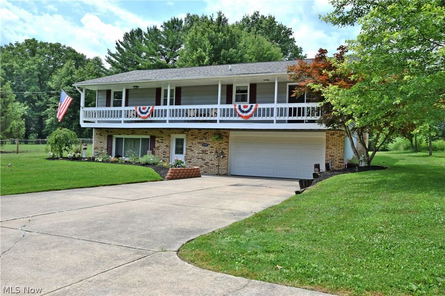 Beautiful Bi-Level home on 1.03 acres in Southington Schools. The covered front porch that stretches the entire front of the house invites you right in to this move in condition home! Large foyer entry in the lower level with new  wood look tile flooring leads you up to the open concept main living area. Large living room with woodburning fireplace and eat in kitchen with dining area and penninsula island with additional bar seating. Tons of counter and cupboard space in this large updated kitchen! Down the hall, a completely updated bath for 2 bedrooms and guests to share. Large master suite with another beautifully updated bathroom! On the lower level, a 4th bedroom or bonus room, an additional room now being used for storage but could be finished.  A large laundry/utility room and inside access  to  2 car attached garage for added convenience! Large deck in the backyard to sit and watch your whole family having fun in your huge back yard with wooded view. New septic in 2015, and all