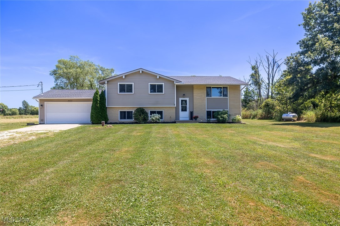Welcome to 3531 Yost Rd in charming Litchfield, OH! Nestled on 6.6 private acres in Buckeye LSD, this spacious 5-bedroom, 3-bath bi-level home offers over 2,200 sq ft of comfortable living space with room to roam. The main level features an updated kitchen (2025) with modern appliances including a 2023 refrigerator and dishwasher, plus a cozy living room and 3 generously sized bedrooms. The walk-out lower level boasts a massive family room with pellet fireplace, two additional bedrooms, a bonus room, laundry, and full bath—ideal for guests or multigenerational living. Major upgrades include a new roof in 2023 and an A/C system installed in 2024, complemented by a heat pump and working electric baseboard heat for year-round comfort. A water filtration system enhances everyday living, and the propane tank is leased. Enjoy outdoor living on the rear deck, or tinker in the attached 2-car garage. Located just off Medina Norwalk Rd, this peaceful property offers privacy and space with convenient access to area amenities. A true gem ready to welcome you home!