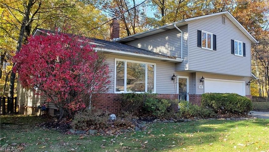 Welcome to this beautiful and spacious home tucked away in a quiet neighborhood of Scottish Highlands! Nestled against a wooded ravine on the border with Richmond Hts, this home comes with a private outdoor deck overlooking the creek below - perfect for relaxing or entertaining. Freshly painted and with new carpeting the upper level boasts three spacious bedrooms and a two full baths. Master suite has a newly remodeled master bath!  The main floor includes a large family room with dining area connected to a large eat-in kitchen with new laminate flooring. Step down into the den for a cozy retreat as you enjoy the crackle of the wood burning fireplace and take in the serenity of nature. Finished basement featuring custom built-in cabinets can be utilized as a home gym, office, spare bedroom or entertainment room. New light fixtures throughout, updated electrical panel and much more! Large vacant lot (not included and can't be built on) next door provides even more space and privacy. Clo