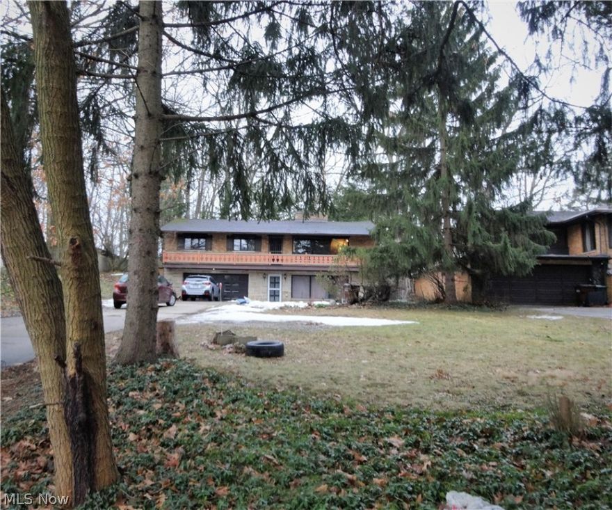 Welcome Home! Raised ranch with so much charm and character on almost an acre parklike lot! Walk out basement. So much work has been done to this property in the past 3 years including updated main level kitchen and bath and new plumbing, flooring in the living room, dining room and kitchen, grading and landscaped back patio and path leading to backyard. All appliances stay.  Living room, kitchen and dining area has vaulted ceilings with exposed beams, many large windows and walk out veranda. Living room has fireplace with very ornate copper cover and has Solid Wormy Chestnut Shiplap on some walls. Hardwood floors in the bedrooms.  Attached heated garage with workshop and storage rooms. Driveway has additional cement pad parking area and turn around.  Lower level has separate entrance, many large windows, fireplace,  can be used as an in-law suite. Must See!