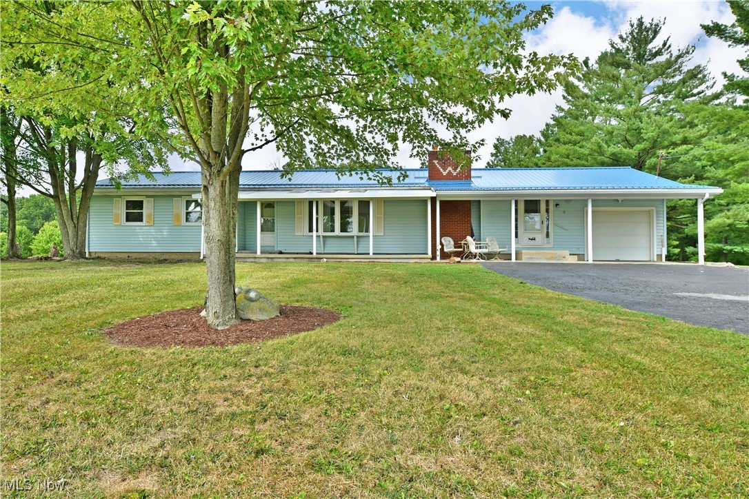 Looking for a little more room? What about a lot more room? Look no further as this remarkable Southington ranch has all the space you need and more! This potential packed home sits far off the road at the end of an outstretched blacktop driveway, placing you well within the expansive property. Scenic surroundings and natural privacy make this homestead truly one-of-a-kind, with a front porch view you have to see to appreciate. With its bold, blue metal roof and covered front and rear patios, this home makes outdoor relaxation a breeze. A single car garage is available while additional covered storage wraps around the back where plenty of room for expansion is available. Step through the front door to find a spacious, carpeted living room that takes full advantage of the large picture windows. A recessed area creates a perfect gathering spot as you take in the towering brick mantle and inset fireplace. Across the hall, a combined kitchen and dining room are highlighted with beautiful stone countertops and warm wooden cabinetry. Meanwhile, a half bath sits adjacent to first floor laundry before transitioning into a sizeable rec or family room set near the garage. Opposite the home, three spacious bedrooms accompany a handsome full bath and its brightly colored shower. Additional storage space can be found within the full basement below. Call today for more information!
