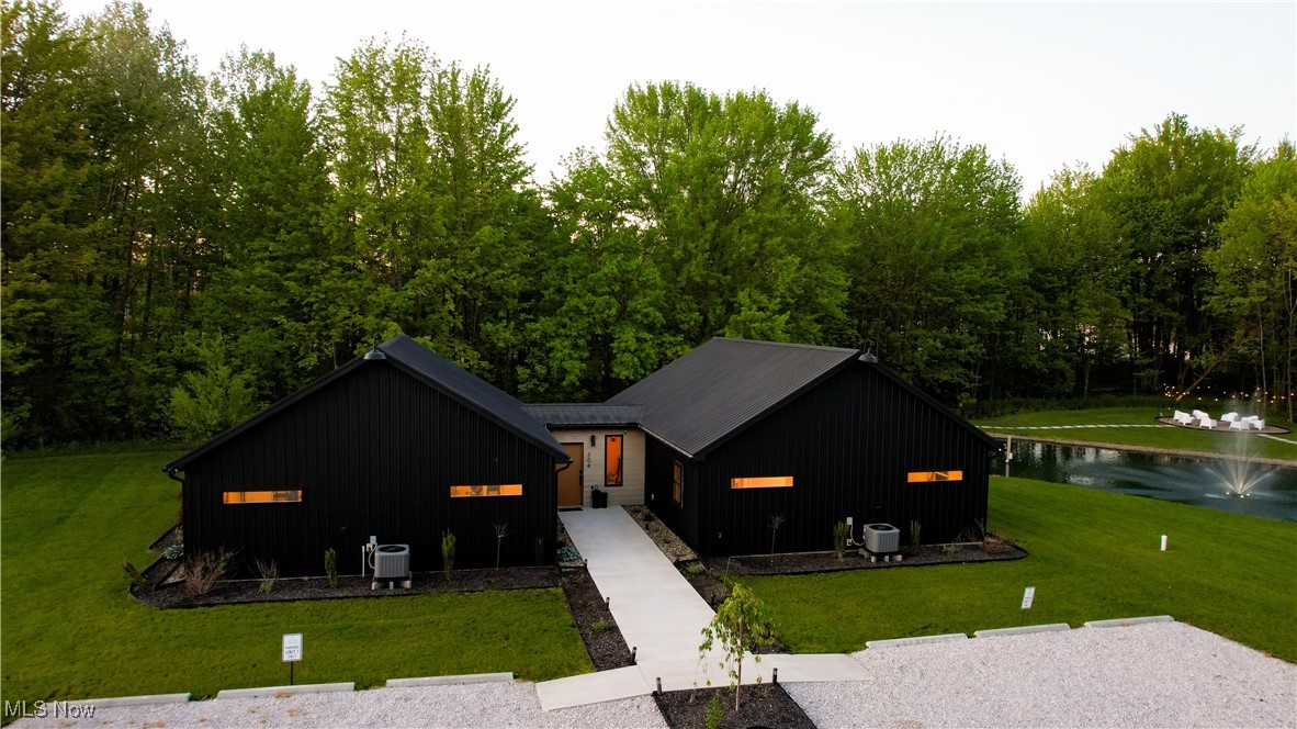 Exceptional investment or retreat opportunity in the heart of Ashtabula County’s wine country! This 2.4-acre property offers THREE fully furnished 2BR/2BA cottages (each 900+ sqft plus shared vestibule), Amish-built in 2022 with designer finishes and quality craftsmanship. Everything is new—including appliances, septic, and a commercial-grade electric well system large enough to service a hotel. Each unit features poplar wood walls, Bedrosian tile baths, All Samsung with some Frame TVs, full kitchens, Arhaus/Four Hands furnishings, platform gel foam mattresses, and programmable thermostats. Forced electric heat and A/C. Outside you’ll find over $100K in pro landscaping, a stone fireplace with seating area, pond with programmable fountain, solar lighting, and dedicated concrete parking. Currently successful STRs generating $250–$350/night/unit with conservative 10–12 nights/month. Managed on Airbnb, VRBO, and Booking.com. Minutes to Geneva-on-the-Lake, SPIRE, golf, and 30+ wineries—ideal for investors, retreats, or live-and-earn!