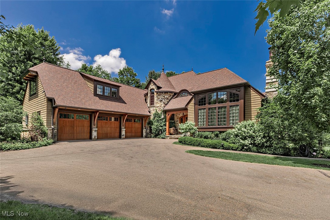 Come experience the perfect blend of luxury and nature in this stunning custom-built country estate, set on 5 thoughtfully landscaped acres. Built in 2014 by Pistone & Tesauro Builders, this Anthony Paskevich-designed home offers timeless elegance and year-round comfort and beauty.
The main level features a private primary suite with fireplace, spa-like ensuite bath, and dual walk-in closets. An open floor plan includes an expansive great room with fireplace, spacious dining area that opens to a large deck terrace, and a well-appointed kitchen with butler’s pantry and walk-in storage. A sizeable screened-in porch provides breathtaking views of the exquisite yard. The attached three-car garage includes a dog wash and ramp to the mudroom. A year-round hot tub sits just outside for all-season relaxation.
Upstairs, two oversized bedroom suites with walkout terraces offer comfort and privacy. A large, heated and wired attic is ready to finish as a fourth bedroom or bonus space.
The walk-out lower level is an entertainer’s dream—featuring a sports bar with pool table, keg room, half bath, and walkout to a covered patio with outdoor fireplace. This level also includes a private office with fireplace and cigar patio, a hidden theater room, and a bright fitness room with full bath and sauna. Just steps away is a two-lane outdoor lap pool.
The exterior is equally remarkable. Surrounded by a scenic river and featuring a large stocked pond with small- and largemouth bass, outdoor pursuits abound. Cast a line from the rowboat or stroll through gardens lovingly curated and cultivated. A multi-level detached garage and attached full greenhouse, added in 2016, expand the opportunities and property's versatility.
A Control4 home automation system and a Rainbird irrigation system both provide added convenience and peace of mind.
This extraordinary home offers gracious living in a truly one-of-a-kind setting—where every detail, inside and out, has been thoughtfully considered.