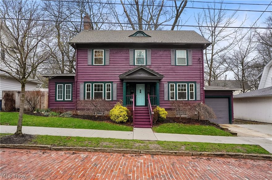 Beautiful, traditional century colonial located in the heart of desirable Highland Square, set along a charming brick road. From the moment you step into the stately foyer, you’re welcomed by a classic built-in bench and elegant winding staircase that set the tone for this timeless home. Flanking the foyer, the inviting living room features a fireplace, gorgeous wood trim moldings, and access to a recently renovated sunroom with vaulted ceilings—perfect for relaxing or entertaining—with direct access to a private, paved stone patio. On the opposite side, the spacious formal dining room showcases a chair rail detail and connects seamlessly to a bright breakfast room, making this home ideal for hosting gatherings. The updated kitchen offers both style and functionality, complete with stainless steel appliances, granite countertops, and an expansive pantry.  Upstairs, a cozy loft area provides flexible space, while the oversized primary bedroom connects conveniently to the full bath. Two additional bedrooms are located on the second floor, one of which is currently used as a generous walk-in closet—perfect for extensive wardrobes. The bathroom retains its original 1920s tilework, beautifully preserved and full of character. The walk-out basement leads to a one-car garage and offers ample space for storage, laundry and a water closet with a commode. The yard is mostly fenced, requiring only one side to be enclosed—ideal for pet owners. Enjoy an unbeatable location near bike trails, Memorial Parkway Dog Park, the vibrant shops and restaurants of Highland Square. Recent updates include: Wood fence '25, vinyl windows '26, lighting '26, granite countertops '26, refinished hardwood floors on the main level, furnace '24, water heater '24, A/C '24, sidewalks and parking pad '25 and much more.
