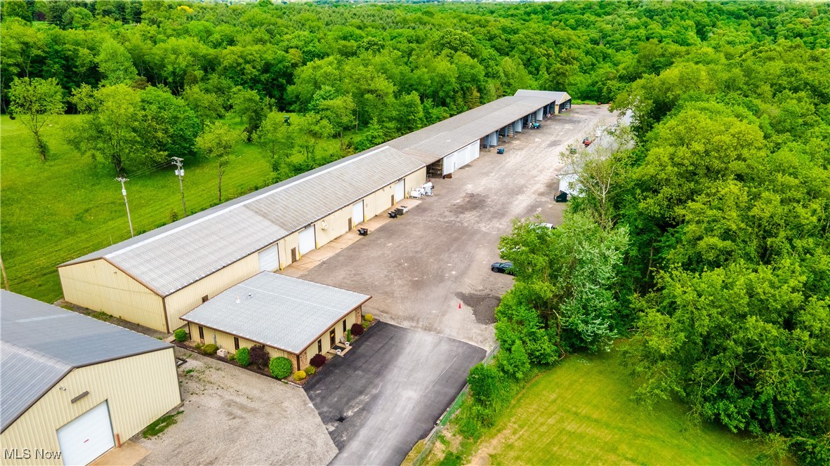 This impressive commercial property is packed with potential and ready to support your business dreams! Set on over 6 private acres, it offers a sprawling 28,200 sq ft of industrial space that's insulated, well maintained, and equipped with 14-foot bay doors, built-in cranes, and an air compression system—ideal for heavy equipment, fabrication, or industrial operations. Beyond the main industrial space, you'll find an incredible 31,750 sq ft of open, covered garage bays that provide ample room for fleet storage, staging, or expansion. There is also finished office space of 2600 sq ft. With additional outside parking and all utilities available, this property is as flexible as it is functional—ready to adapt to your unique needs in a secure and versatile setting. The 2600 sq ft of office and 6000 of industrial is currently leased with a solid renter bringing in $5700 a month perfect to offset any monthly debt service or operating costs. Don’t miss this rare opportunity to own a powerhouse of a property that’s built for big ideas!