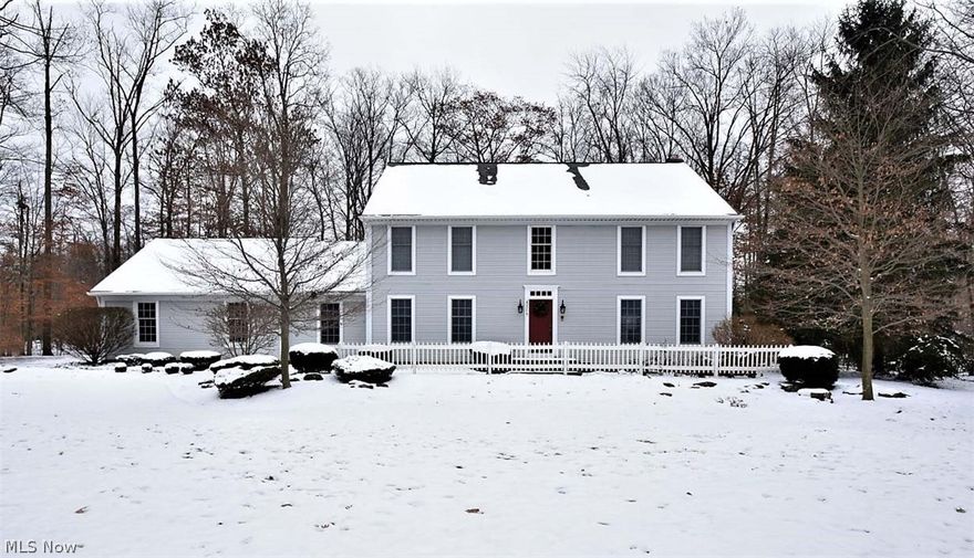 Inviting New England Style Colonial with a gorgeous two-story Foyer, turning staircase and hardwood floors throughout the entire first floor. The Living Room has French doors to a large Family Room with beautiful moldings and a traditional fireplace with a gas starter, lots of windows and views of the wooded backyard. The Kitchen has stunning cherry cabinets, granite counter tops with a large island and opens to all rooms for a great flow. A vaulted screened in porch off the Kitchen leads to the newly landscaped and fully fenced in yard. The back hallway leads to the Laundry, half Bath, a Library with built in shelving and the 2 car garage. At the top of the stairs enter the vaulted Master Suite through double doors with his and her walk in closets and a huge en suite Bathroom with double sinks, jetted soaking tub and a separate stall shower. There are 3 more Bedrooms and a 2nd full Bath with a vaulted ceiling and skylight on the second floor. The finished Lower Level has a 3rd full Ba