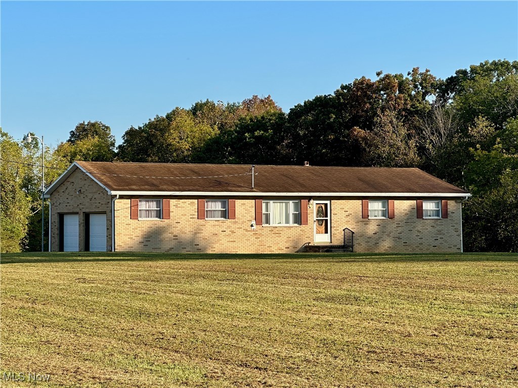 Nestled on nearly 2 acres in the Warren school district, this well-maintained all-brick ranch offers comfort and utility. The home features 3 bedrooms and 2 full baths, with wood floors in each bedroom. The full finished basement, equipped with a kitchen sink, expands your living and entertaining space. Outside, the large, flat front yard provides a perfect canvas for outdoor living. The property also includes a large 2-car garage and a large outbuilding with electricity, ideal for a workshop or extra storage. This home is a MUST-SEE for those seeking space and a peaceful setting.