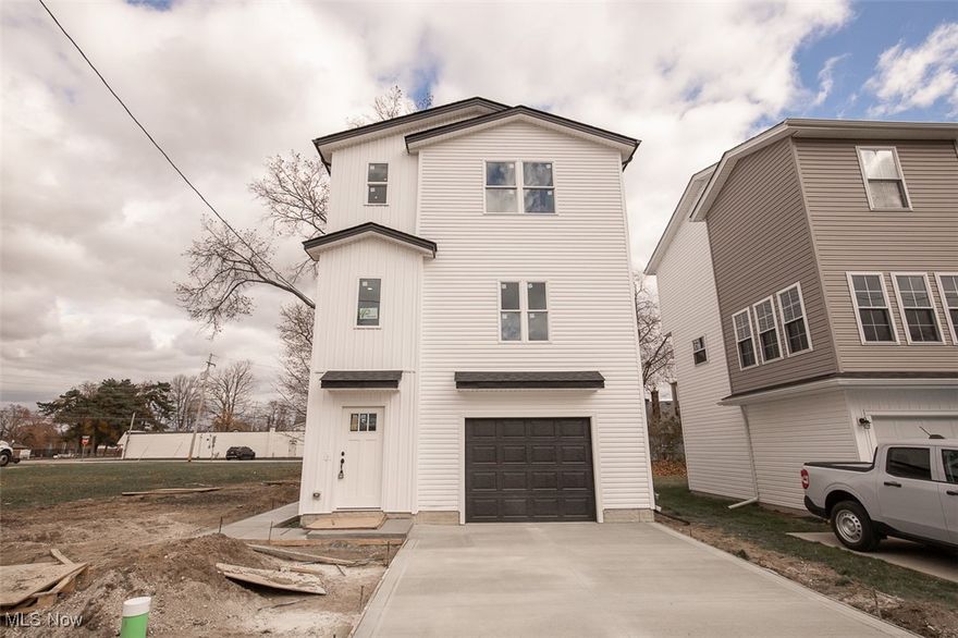 This brand-new, multi-use commercial and residential home is located at 1053 Peach, Willoughby, Ohio. A stunning three-story property offering versatility and modern finishes.  

The first floor welcomes you with a grand two-story foyer, durable LVP flooring throughout, and garage access with a one-car attached garage. It also features a private rear entry leading to a multi-use room with a half bath—perfect for a home-based business or guest suite.  

Upstairs, the second floor boasts nine-foot ceilings, an open floor plan with LVP flooring, a half bath, and a contemporary kitchen with white cabinets, soft-close drawers, and quartz countertops. Enjoy views of the front and rear yards from this level.  

The third floor includes three spacious bedrooms with plush carpeting (except in the bathrooms and laundry area), a full bathroom, and a convenient laundry area. The master suite features a walk-in shower and a luxurious master bath.  

Located within walking distance to stores, this home combines comfortable living with flexible space for business or personal use. An ideal investment for modern, multifunctional living. This home also qualifies for a 5 year tax abatement tax credit.