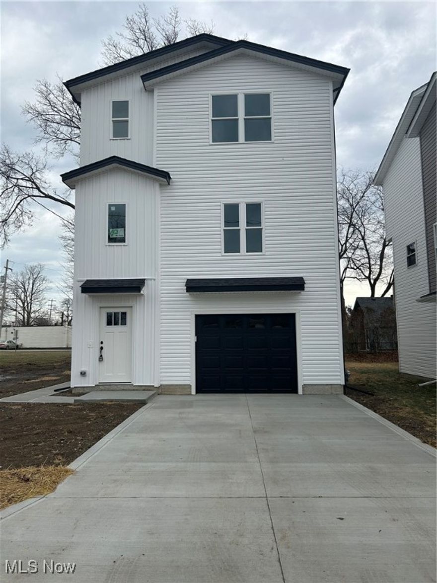 This brand-new, multi-use commercial and residential home is located at 1053 Peach, Willoughby, Ohio. A stunning three-story property offering versatility and modern finishes.  

The first floor welcomes you with a grand two-story foyer, durable LVP flooring throughout, and garage access with a one-car attached garage. It also features a private rear entry leading to a multi-use room with a half bath—perfect for a home-based business or guest suite.  

Upstairs, the second floor boasts nine-foot ceilings, an open floor plan with LVP flooring, a half bath, and a contemporary kitchen with white cabinets, soft-close drawers, and quartz countertops. Enjoy views of the front and rear yards from this level.  

The third floor includes three spacious bedrooms with plush carpeting (except in the bathrooms and laundry area), a full bathroom, and a convenient laundry area. The master suite features a walk-in shower and a luxurious master bath.  

Located within walking distance to stores, this home combines comfortable living with flexible space for business or personal use. An ideal investment for modern, multifunctional living. This home also qualifies for a 5 year tax abatement tax credit.