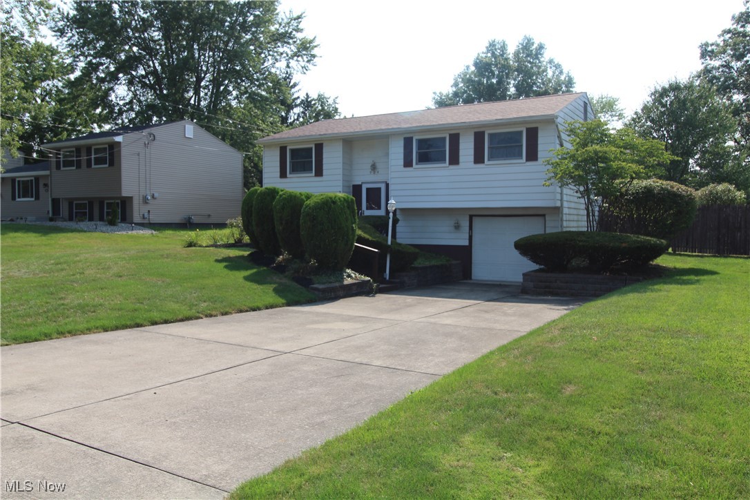 Welcome to this 1748 square foot home, McDonald Schools. Pull onto double wide concrete driveway, extra parking for you and guests. Notice the fresh landscaping as you walk up the brick lined walkway to front door. Once inside the landing leads up to the main level as well as to lower-level living space. The Living room is a generous 14x10, offering multiple options for furniture placement. Living Room blends into the Dining Room which features double wide sliding doors leading to a newer deck. Kitchen features Refrigerator, Range, Dishwasher, Microwave and disposal. Hallway offers a double wide closet/storage area. A full bathroom offers decorative flower tub/shower combination, and a custom Oak clothes shoot. The Master Bedroom is 11x10, with a double stained-glass closet. The second Bedroom has Oak doors, carpeting, with custom closet features of floating shelving and upright vacuum holder. Third Bedroom also offers Oak doors, carpeting, floating shelves in closet. Head downstairs where there is a generous 22x17 of living space waiting to be customized. Half Bath. Utility Room with Washer & Dryer, sweater drying rack, wet sink. A Workshop is just off garage for your home improvement projects. The Garage floor was replaced in 2022. Sump Pump in garage. The back yard is fenced with a newer Raised Deck. This home features a generator for peace of mind. Interior has been professionally cleaned, painted, and carpets cleaned in last few months. Roof new 2020. Call for a private tour of this home.