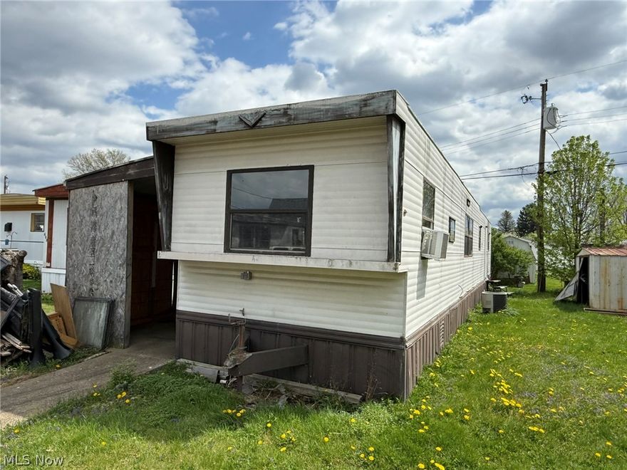 Convenient 1 story living.  Kitchen includes range and refrigerator.  Stackable washer/dryer included.  Home needs TLC.  Subject to park approval, $45 application fee for credit and background check.