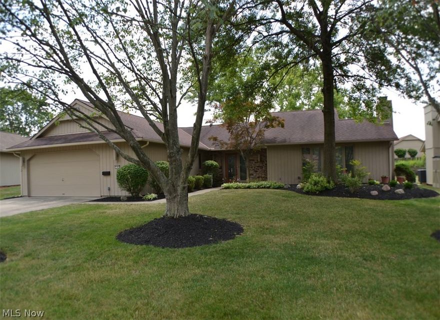 This immaculate Meadowood home features a spacious great room with wood burning fireplace, large dining room, wonderful eat-in kitchen with custom cabinets, two large pantries, under cabinet lighting, stainless steel appliances include a GE cook-top range, GE microwave, Bosch dishwasher, Amana refrigerator, Corian counter-tops, tile back splash and hardwood floor, three spacious bedrooms - master with full bath with shower and cultured marble double sink vanity and large walk-in dressing room with two custom wardrobe chests, huge laundry room with Bosch washer and dryer, utilitub, extra storage closets, folding counter, and hardwood floor, generous two-car garage with Genie door operator, pegboard walls, hot and cold water, floor drain and pull-down stairs to overhead storage, large foyer with hardwood floor, crown molding and guest closet, bright and cheery sun room with Nature Stone floor, Aprilaire humidifier, irrigation system, custom window treatments, fantastic cul-de-sac lot, an