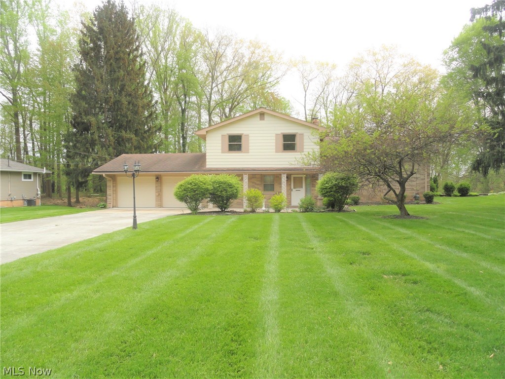 Impressive 5 level Split Level home situated on a 1/2 acre semi private lot on a cul-de-sac street in a very lovely neighborhood. The foyer entry opens to the formal living and dining rooms with a soaring beamed cathedral ceiling and generous sized windows welcoming the sunlight. The eat in kitchen overlooks a spacious family room adjacent to the office or 5th bedroom plus a full bath. The four spacious bedrooms upstairs have beautiful hard wood floors, double closets and ceiling fans in each room. There is a lower level walkout rec room/laundry room and an additional lower level basement with built in bar. Beautiful backyard backs up to small wooded area. Home Warranty included. This home has been well loved and maintained for many years and is ready for your updates.