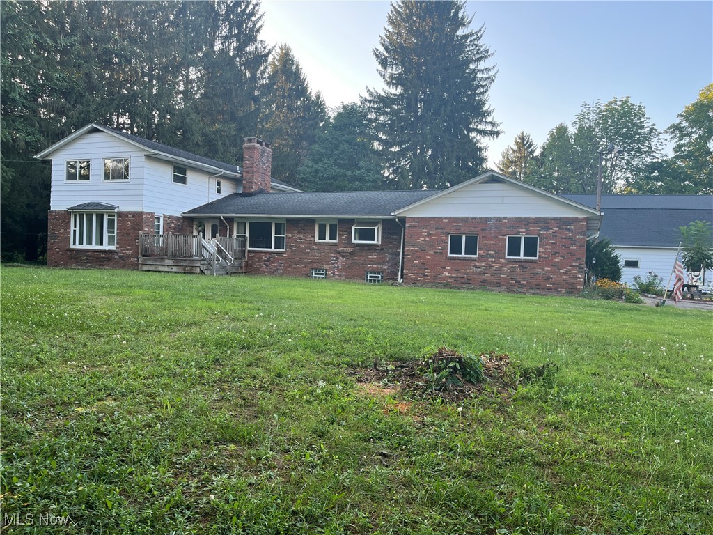 Rare opportunity exists with this nearly 3,000 sq. ft. home. An att. 2-car gar, sitting on 2.69 acres in Burton Twp., this sprawling 5-bedroom, 5-bath home (3 full, 2 half) has an additional living suite on 2nd floor, as well as the potential to run a business out of lower level (which has its own entrance/exit). Main floor boasts a newly remodeled kitchen, 1st floor laundry, half bath off dining room, and wood-burning stone masonry fireplace in family room. Large picture windows in this home flood every space with light! Large walk-in closet down the hallway off 3 bedrooms, has one of the full baths. At the end of the hallway, a set of stairs leads to the upper suite, consisting of a living room, kitchen, dining room, full bath, and large bedroom. Balcony off dining room. Add some steps to it & allow a renter to gain their own access into/out of unit. Let someone else help pay your mortgage! In basement, there is another full bath and a 2nd (see-thru) stone masonry woodburning fireplace. There's an 18.5' x 11' fruit cellar/storage area, but the door giving ingress/egress from outside into the basement offers the most potential of all. Run a business out of a 26.5' x 12.5' space! Water heaters, 2018 & 2019. Furnace and A/C, 2024. Broiler, 2005. Well water pressure tank, 2017. Roof, 2008. There is a 3-story 50' x 27' bank barn! Ramped back entrance to house for disability access. Treed lot has a small pond on it & is just West of historical Burton Village. It's not very often that a property with this much promise comes by. Why not make it yours today?