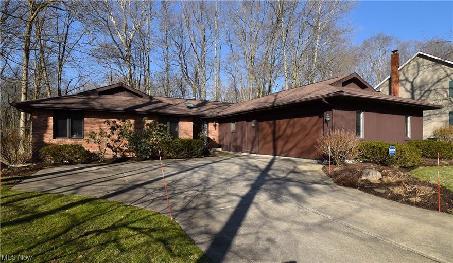 Exceptional, pristinely maintained, Brick and Cedar sided ranch home situated on almost half acre picturesque wooded lot. Spacious floor plan with wood floors in main rooms, carpet in bedrooms. Entry foyer with 2 closets and convenient powder room. Nice sized eat in kitchen extends to family room with wood burning fireplace, skylights, floor to ceiling windows and a slider to the deck. Gracious living-dining room  perfect for entertaining. The ample primary suite includes a large walk-in closet, vanity dressing table, ensuite full bath and fabulous private 3 season room with soaring wood ceiling and wrap around windows.  A large basement with wet bar is perfect for play, crafting or spending time with friends. The tranquil backyard is a sanctuary withmature trees, small creek, birds and wildlife. The community offers recreation area with pool, tennis courts clubhouse and playground. Minutes to 422, shopping and Chagrin Falls. Showings begin Friday, 3/8/2024 at noon.