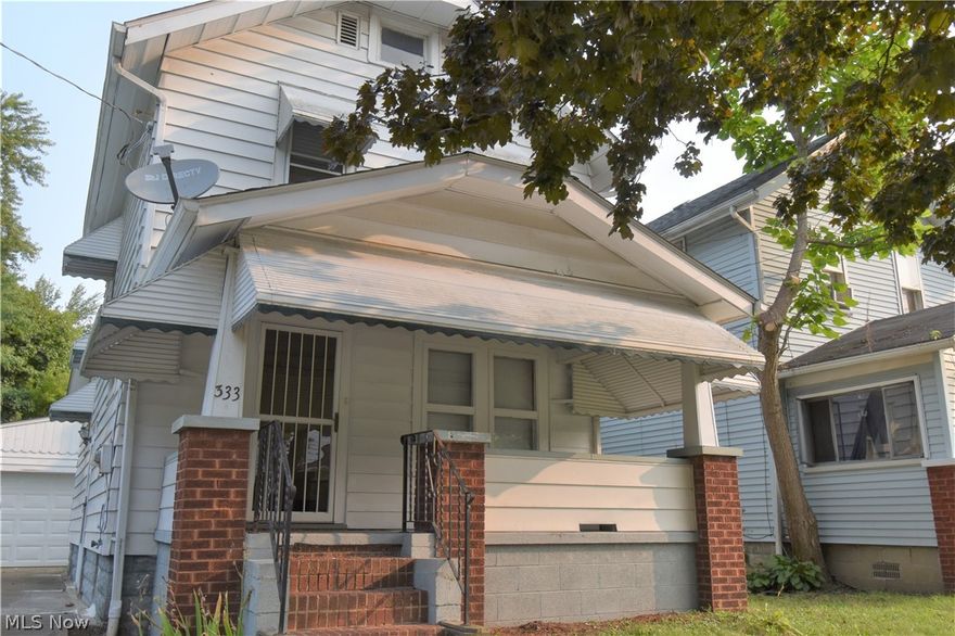 Welcome to 333 Upland Avenue in Akron! This 2-bedroom, 1-bathroom home has convenient access to both I-76 and I-77. The spacious covered front porch offers a wonderful place to sit and relax outdoors, rain or shine. Step inside to see beautiful updated flooring and original wood work baseboards and trim. The living room, dining room, and kitchen are all located on the main level, along with a convenient storage area. The dining room has lovely built-in drawers underneath a large picture window. A convenient two-sided breakfast bar connects the dining room and bright and sparkling clean kitchen. Two bedrooms located upstairs, along with a bathroom. Basement walls and floors are freshly painted. Don’t let this home get away – schedule your private showing today!