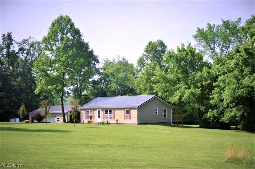 Ranch style home in pristine condition.  Located in the Maysville SD this home offers 3 bdrms., 2 baths and is situated on a private lane on 2 acres.  Lane is paved back to the homes driveway.  Small cute pellet stove included to reduce the cold winter heating bills.
New flooring in the galley kitchen,  the seller is leaving the stove, refrigerator, dishwasher, washer and dryer for your convenience.
Nice private back yard with newer deck for enjoying the warm weather days and wildlife.  Small one car garage for storage or small car close to the house and fabulous newer built 30x40 sq. ft. shop/garage/workshop insulated and wall air unit.  This garage is a great addition to the property with lots of electric outlets, breaker box and 2 double car garage doors, built in work benches. Large mounted TV can stay with property also.  Quick possession.  More pictures to come.  Very nice find... Manufactured home