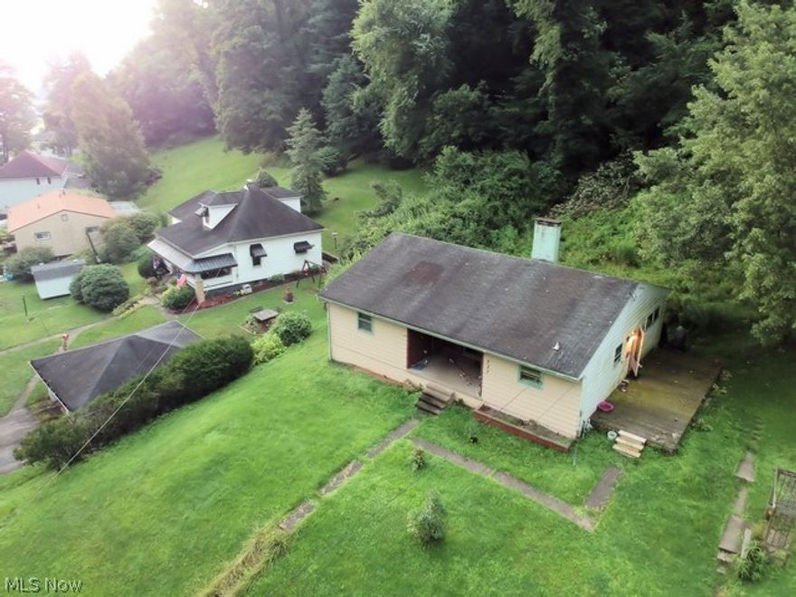 Located in the Ohio River community of New Matamoras. Sited up on a hill away from traffic noise this home is surprisingly large with 3 full bedrooms, huge living room and healthy sized kitchen. To top off the size question, it has a full basement to round things out. There is a covered porch in front and a side deck and level side yard providing a lot of exterior space for recreating.