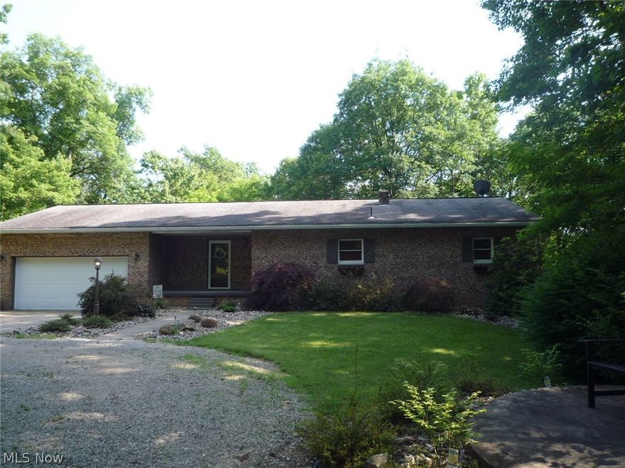 A private paradise just minutes from Marietta! This beautiful brick ranch has been totally updated. Newly remodeled spacious kitchen offers Hickory custom cabinets, granite countertops, travertine back splash, ceramic floors & SS appliances. Both baths have been tastefully remolded. All flooring has been replaced with new Bruce hardwood, ceramic or carpeting. All doors and trim replaced. Interior painted in modern colors. Everything redone and 100%  move in ready! 5 acre lot is treed and private. Can't see your neighbors! 30x40insulated pole building has it's own 200 amp electric and concrete floor. What a man cave! Storage barn with concrete floor and another storage building with kennel. House heated by electric heat pump with propane furnace. Dual fuel cooking range. Propane burners and electric oven. Full unfinished basement and attached garage. 3 level back deck to relax and enjoy Mother Nature. What are you waiting for? This home is calling for you!