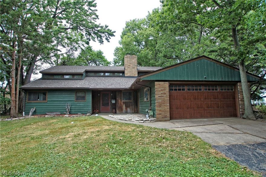 Welcome to 32321 Lakeshore Blvd. This lakefront home offers spectacular lake views from almost every room! The secluded lot offers sought-after privacy in Willowick and the house has a mid-century modern vibe. Four bedrooms, two bathrooms and an open concept living room offer more natural light than most homes. The wood-burning fireplace is a nice feature for NE Ohio winters. The house is equipped with two separate HVAC systems and the added bonus of a whole house exhaust fan. The light and airy eat-in kitchen has beautiful granite countertops and an abundance of storage. The backyard is the best part! An above ground pool, 20 x 24 outbuilding and endless Lake Erie sunsets all in a private setting can be yours.  Bring your ideas for updating and make this your lake house dream-come-true.