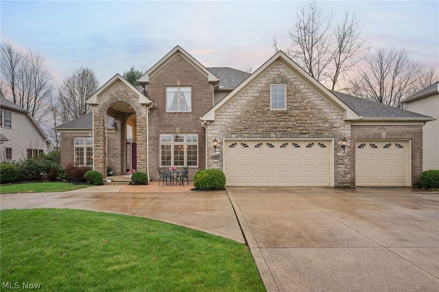 Custom-built, one-family-owned brick-front Colonial set on over .3 of an acre property in the Falmouth East community of Strongsville, featuring a 1st-floor primary suite, attached 3-car garage, deck with a custom motorized awning, and a private fenced backyard with wooded views. This spacious and well-maintained home offers 4 generously sized bedrooms, 2.5 baths, and over 4,057 sq ft of living space, including a partially finished basement with lots of potential for additional living space, rec room, or home gym. A grand 2-story foyer with columns frames the entry to formal living and dining rooms, creating a classic yet open feel, and natural light fills the home through an abundance of large windows. The dining room is appointed with a Waterford crystal chandelier, while the foyer chandelier features a hydraulic lift for convenient maintenance. An eat-in kitchen has a functional center island and opens to a morning room for everyday dining and a cozy hearth room with access to the deck and a dual-sided fireplace shared with a vaulted great room. A wall of Palladian-style windows in the great room captures the beautiful backyard views. The 1st-floor primary suite offers a comfortable and convenient retreat, complete with a walk-in closet and an en-suite bath featuring dual vanities, a jetted soaking tub, and a separate walk-in shower. A 1st-floor laundry room and central vacuum system add to the home’s convenience and functionality. INCLUDED are ALL kitchen appliances, washer/dryer, window treatments, and a 1-year home warranty. Conveniently located near I-71, I-80, OH-82, Cleveland Hopkins International Airport, SouthPark Mall, Mill Stream Run Reservation, and plenty of shopping, restaurants, and other local attractions. This home is a must see!
