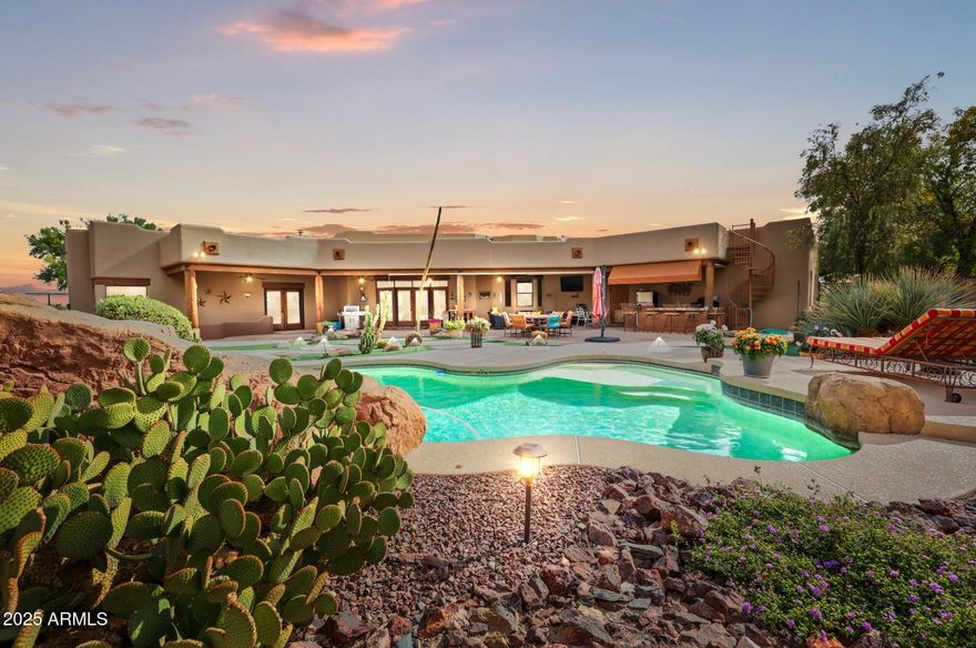 A rare offering in Vista Royale: an 8.17-acre luxury equestrian estate bordering State Trust land with elite roping/horse facilities. The property includes an arena with sprinkler system, round pen, covered runs/stalls, oversized turnouts with automatic waters, covered hay sheds, tack areas, heated wash rack, full RV hookups, and an oversized RV/shop building making it one of the most complete setups in the area. This custom home offers an open great room, chef's kitchen, and resort-style outdoor living with a heated pool, grass and synthetic turf, and built-in BBQ. A private-entry two-office suite adds flexibility for remote work or on-site operations. With a private-entry mother in law suite, and 900 sq ft casita, the property is ideal for hosting or multigenerational living
