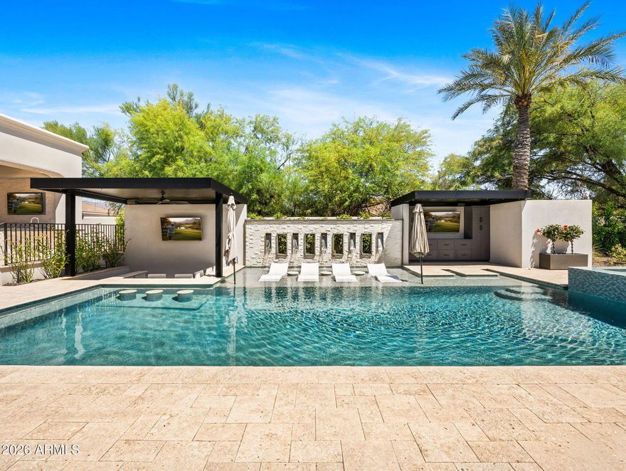 Experience the pinnacle of sophisticated living in this fully reimagined contemporary smart home in the heart of the Cactus Corridor. Fully integrated with Control4 automation, the residence features an open-concept chef's kitchen with a built-in espresso station, dual dishwashers & premium appliances. The expansive great room transforms into a private cinema with a concealed projection screen, while floor to ceiling sliders lead to the ultimate outdoor retreat.
The resort-style backyard is an entertainer's dream, boasting a heated & chilled pool with a swim-up bar, zero-edge spillover spa & five outdoor TVs. An elevated culinary pavilion features a teppanyaki grill, dual grilling stations & a fire bar social hub. For active living, enjoy a private pickleball/sport court, putting green & lush turf zones surrounded by over height privacy walls. Automotive enthusiasts will appreciate the extended length 3 car garage, featuring soaring ceilings with the ideal clearance to add vehicle lifts.
The primary suite serves as a true wellness sanctuary, complete with a private sitting room, infrared sauna, steam shower and soaking tub. All secondary bedrooms are ensuite with walk-in closets.