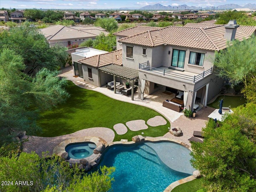 Welcome to this stunning home in the highly coveted, family-friendly Windgate Ranch community! Situated on a premium private lot, offering stunning mountain views from the master bedroom balcony. With 5 spacious bedrooms upstairs, including laundry room, and 6 bathrooms, this home is perfect for a growing family. The property also features a charming casita with a private entrance and full bath, providing direct access to the resort style backyard. The backyard is a true oasis, complete with a heated pool/spa, putting green, and a 2 cozy fireplace sitting areas, ideal for entertaining! Inside enjoy a chefs kitchen, elegant dining room, office, and a versatile bonus room. This Windgate Ranch gem combines comfort, style, and the best of Arizona living.