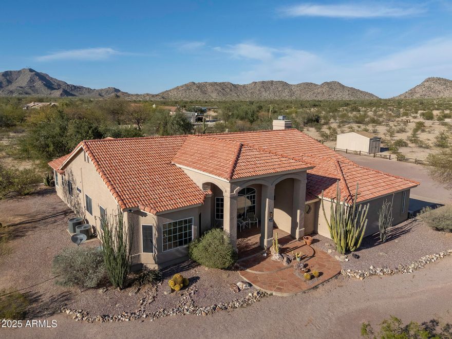 Come discover true desert living at this expansive and gorgeous property. Upon arriving you'll feel the intimacy of its unique and sought after location.  As you approach the front door you'll be welcomed with 4.17 acres of stunning mature cacti and desert trees as well as breathtaking mountain and city light views. This 3 bedroom plus office home boasts newer wood tile flooring, a sunken living room, upgraded bathrooms and chef's kitchen with walk-in pantry, double oven, large kitchen island and is open to the family room.  The primary bedroom has its own separate exit to the patio and the bathroom has a huge walk-in closet and a soaking tub where the views and wildlife can be enjoyed. Outside, sunsets and sunrises can be enjoyed from the patio or deck.  You'll also find an above ground swimming pool, "critter" fountain under an Ironwood tree, a fire pit area, 20 X 12 shed and an oversized 3 car garage.  All this and so much more space for endless possibilities in your own desert oasis.