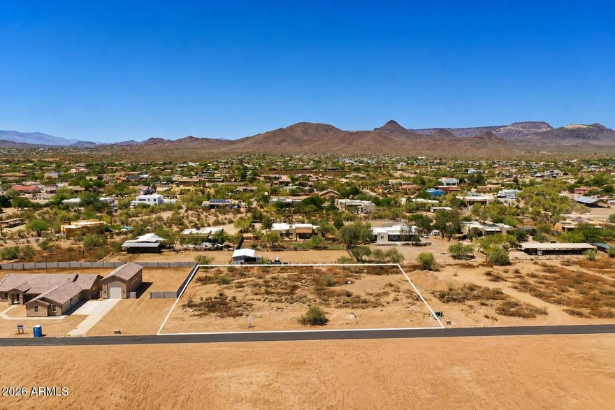Come Build your dream home on this stunning 1-acre lot featuring breathtaking mountain and desert views. Nestled in a peaceful, secluded area, this flat, buildable lot offers ample space with no HOA restrictions, access to a brand new well for water, primary electric to the lot, & a brand new paved road for access. Enjoy the convenience of nearby amenities, including shopping, dining, and healthcare, while being moments from outdoor adventures and the historical town of Cave Creek. Horseback ride, hike, or bike on trails at Cave Creek Regional Park or neighboring paths. With easy access to the I-17 freeway and close proximity to Lake Pleasant, this property offers the perfect blend of tranquility and accessibility.